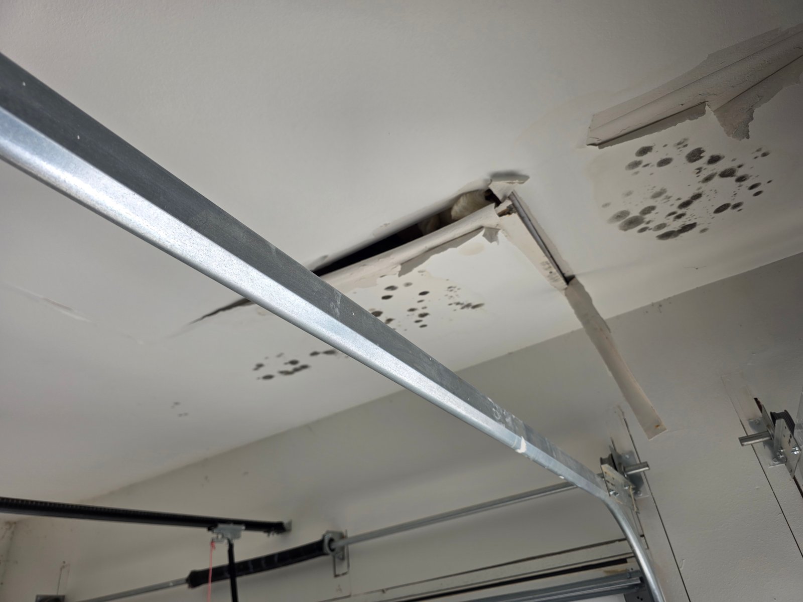 Drywall ceiling water damage and failure caused by window leak in a 2-year-old Tulsa area home